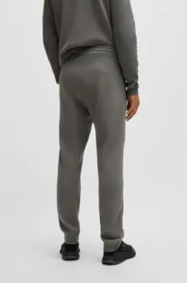 Regular-fit knitted tracksuit bottoms with stripes and branding